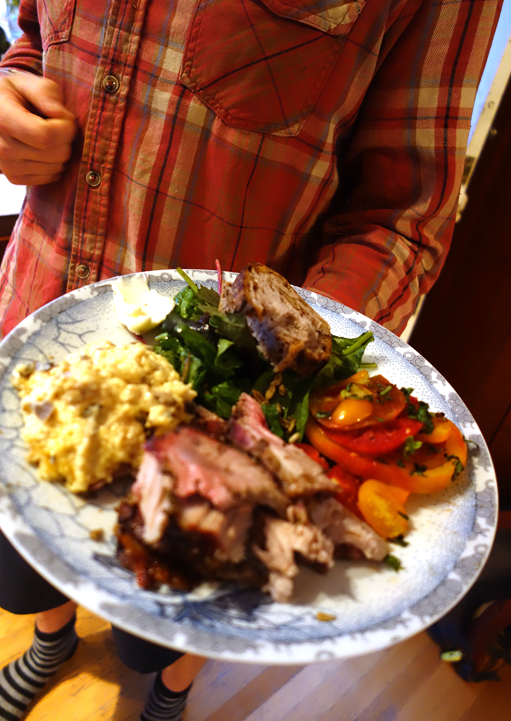 Plate of polenta, pork and tomatoes